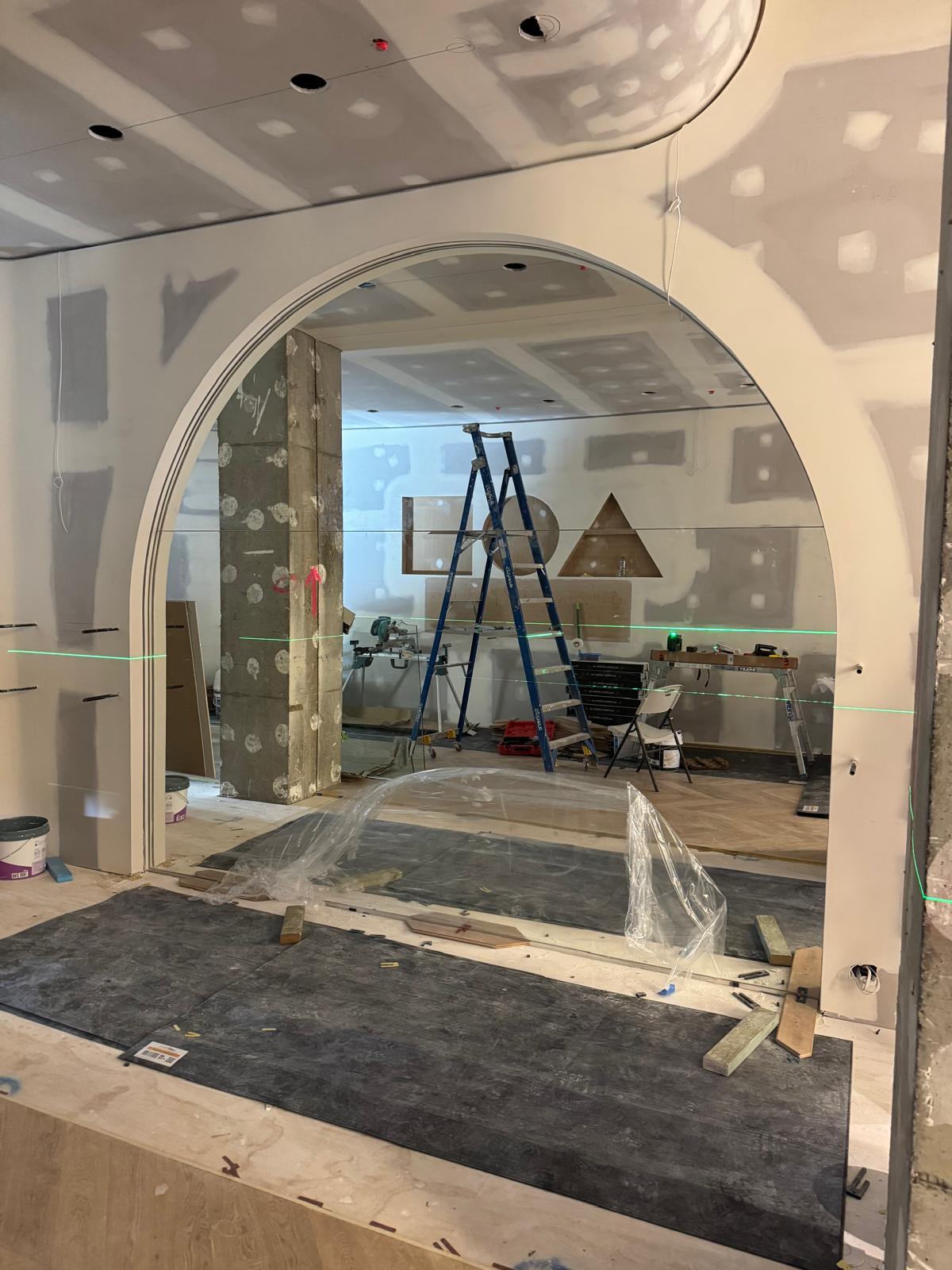 Feature arched mirror wall Sydney with frameless curved mirror design