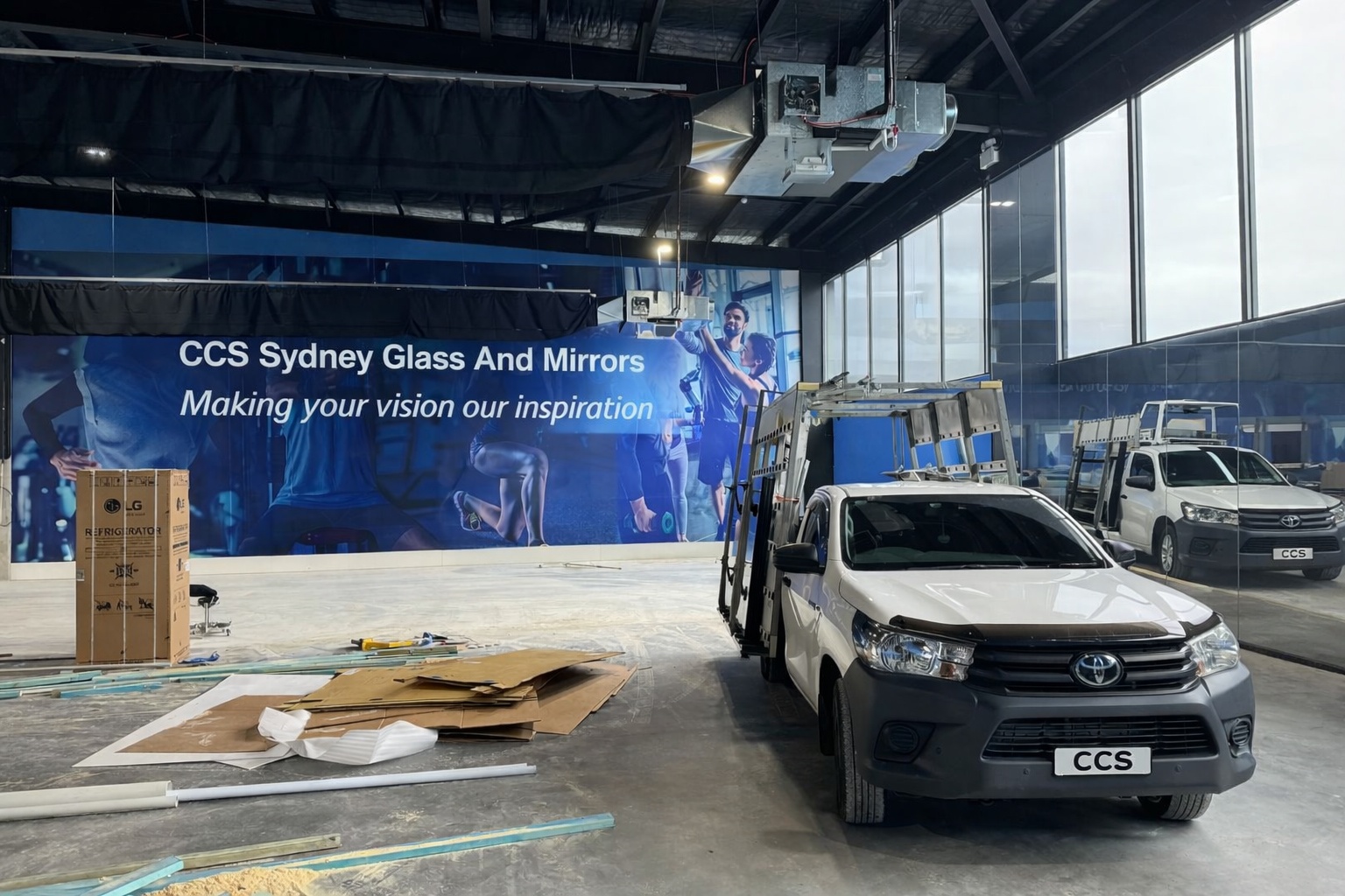 CCS Sydney Glass and Mirrors work ute inside unfinished gym with installed mirrors and windows Sydney