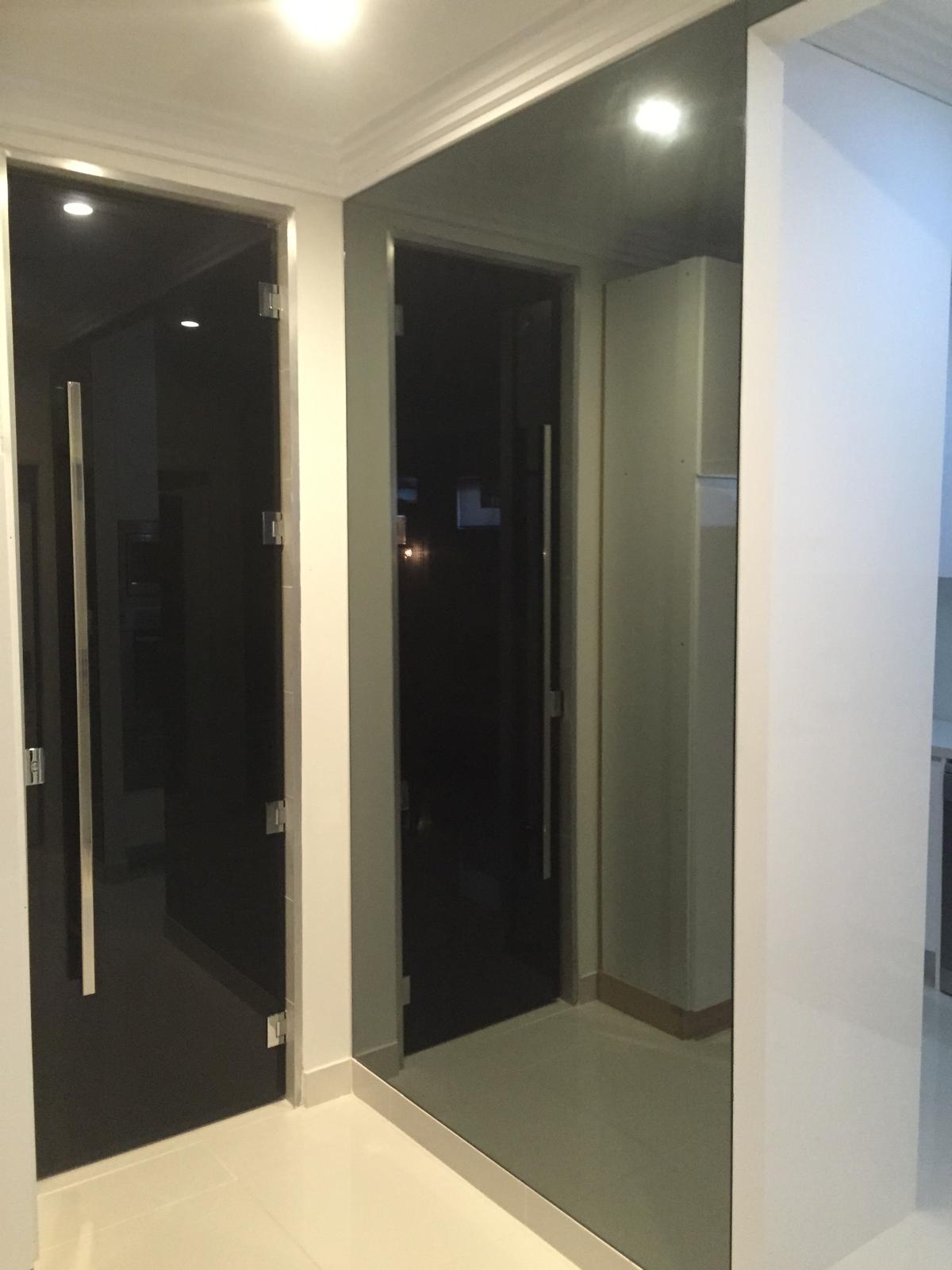Grey mirror wall installed in Sydney home with frameless glass door and modern interior design